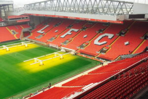 anfield kop stand viewed from main stand with artificial lights on grass