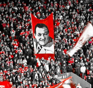 bob paisley flag flying on the kop monochrome and red