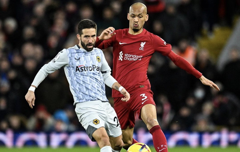 fabinho competes for the ball against wolves