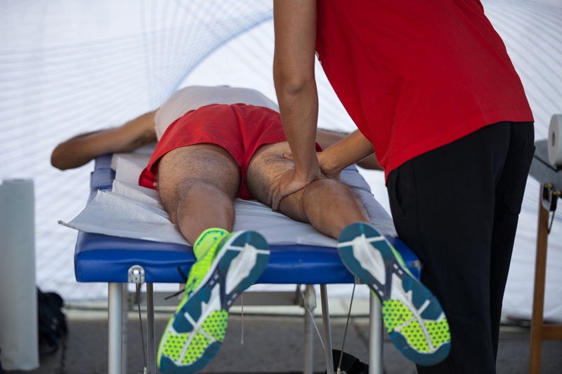 sports physio massaging a players leg
