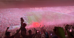 view from kop fans singing red flares after liverpool win league against spurs 2025